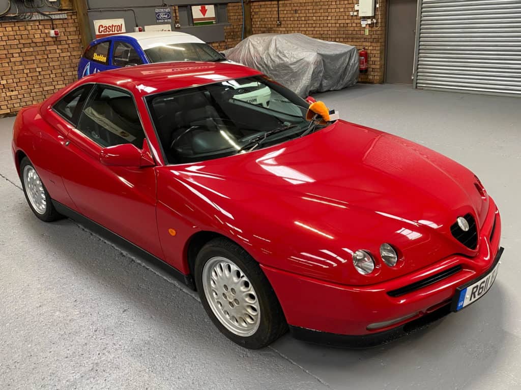 Red Alfa Romeo GTV in storage